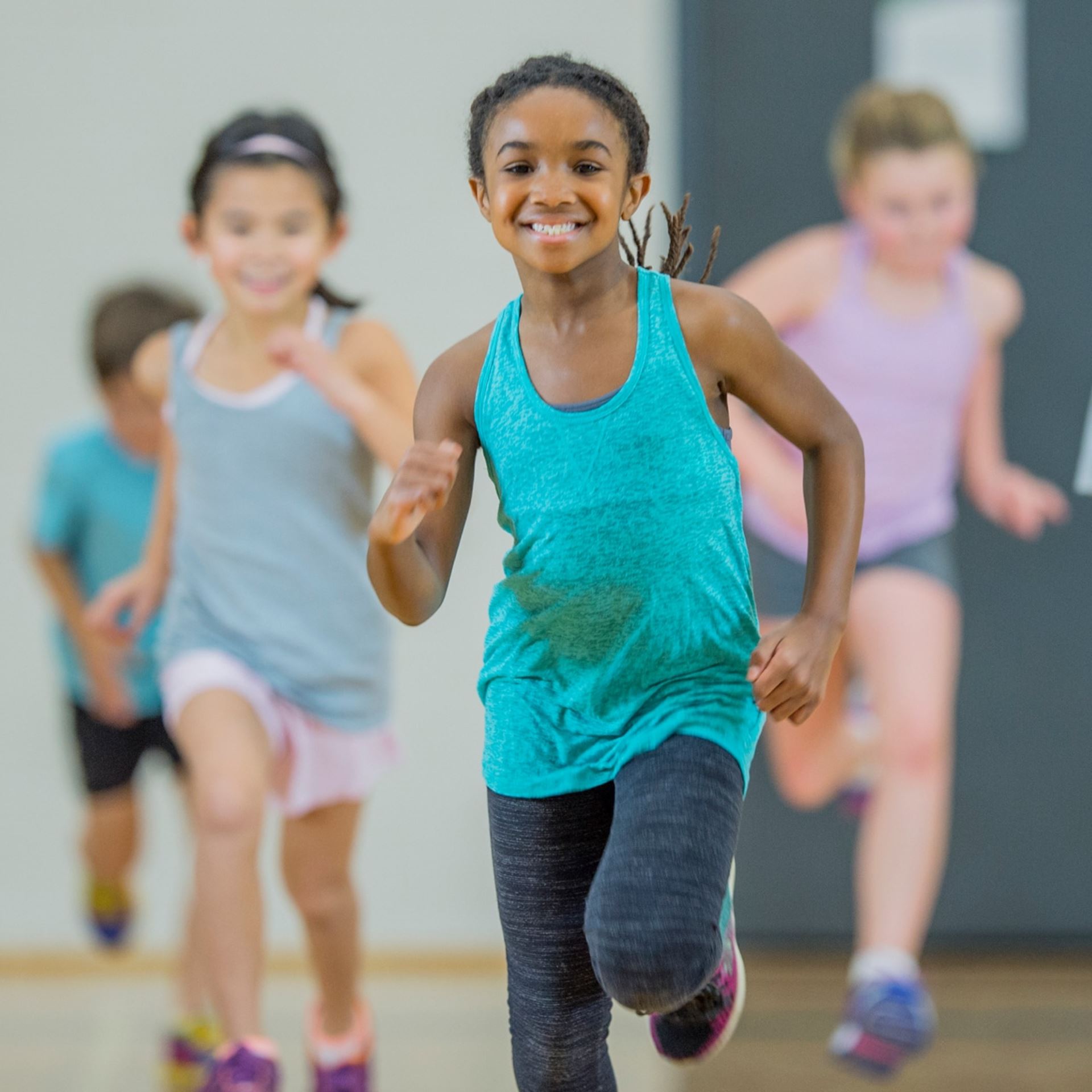 young girl running in gym class