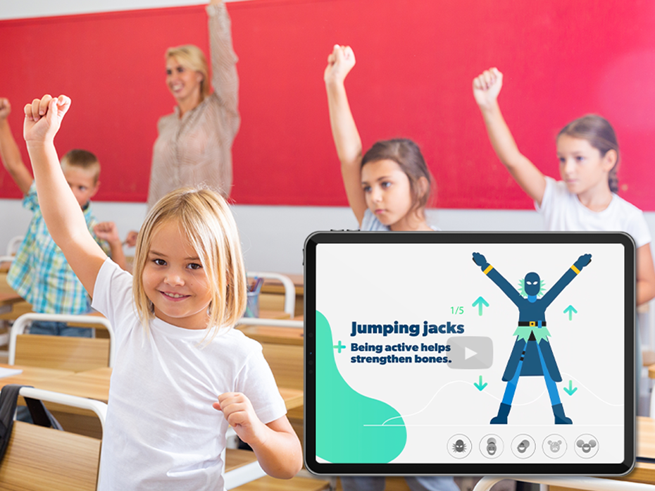 kids in a classroom doing movements beside their desk. Their is an ipad with an avatar.