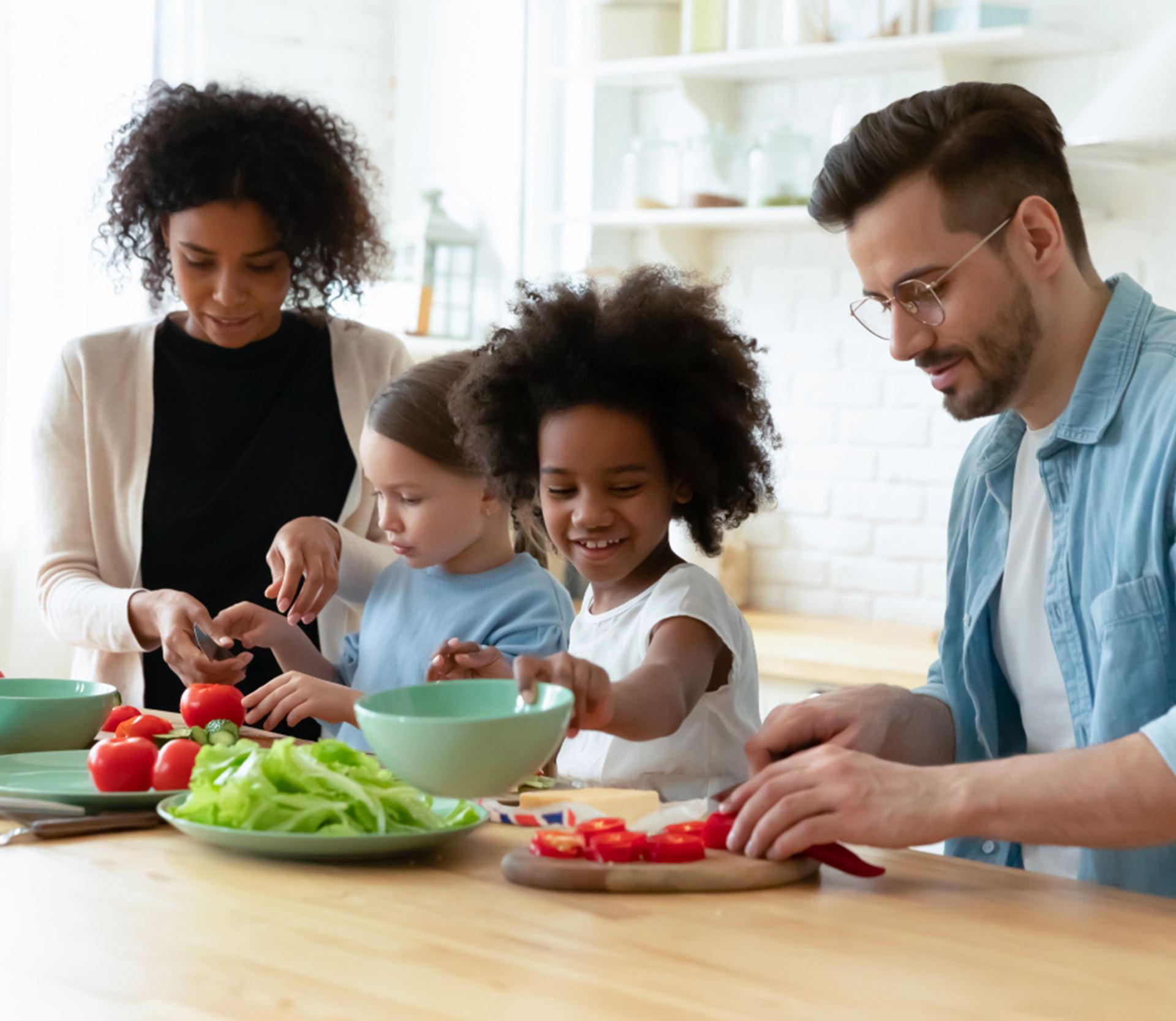 A young family in the kitchen preparing healthy snacks