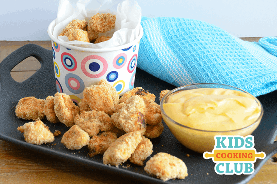 popcorn chicken in a plate with cheese sauce