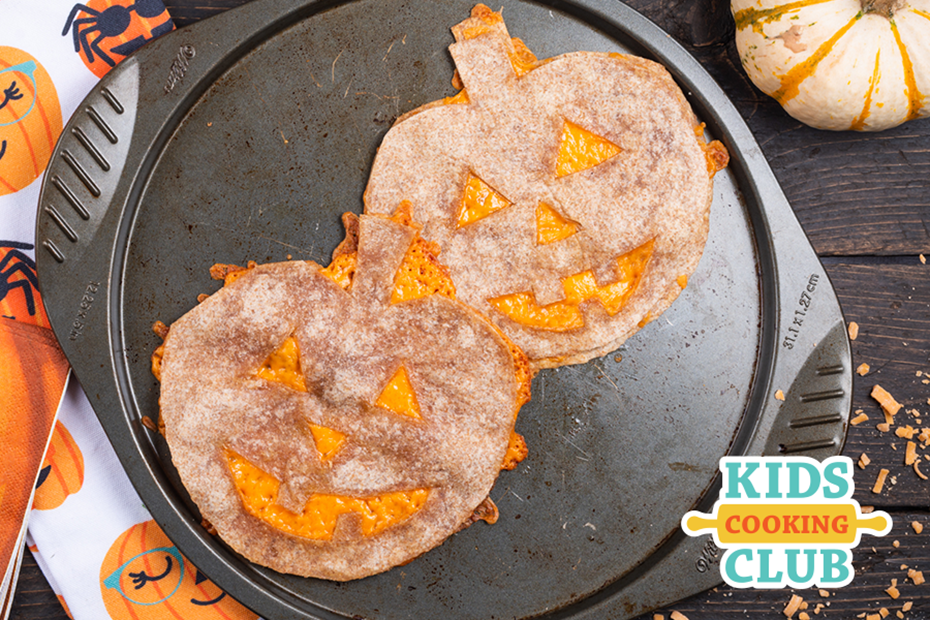 2 tortillas with melted cheese in the shape of a pumpkin- Logo: Kids Cooking Club