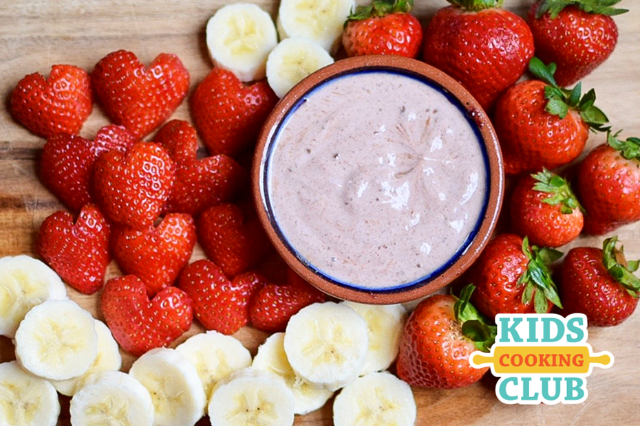 strawberry chocolate yogurt dip in a bowl served with sliced fresh strawberries and bananas 