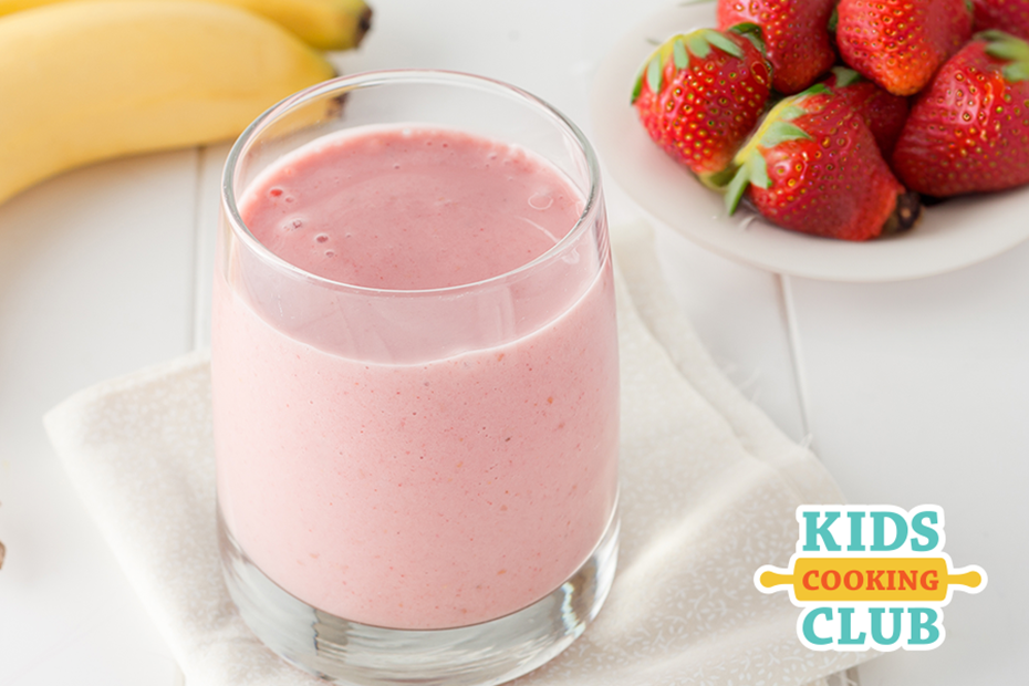strawberry banana smoothie in a glass on a kitchen counter with fresh strawberries and bananas